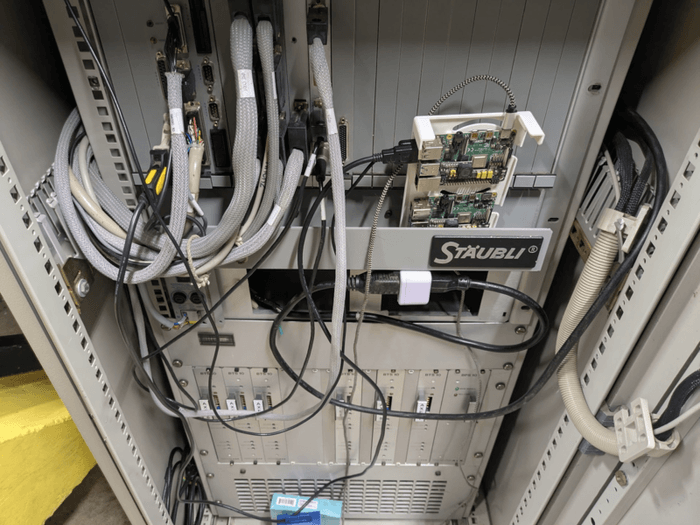 a single board computer in a rats nest of wires inside the control